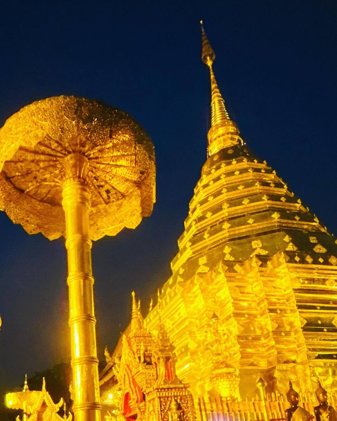 The golden chedi of Doi Suthep glowing at night